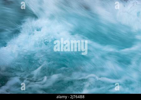 Wild water with splashing spray and current at the glass-clear Rissbach in tirol / austria in the Karwendel mountains Stock Photo