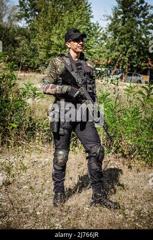 Full armed swat special forces army soldier in combat camouflage uniform. Firearm shooting and tactical training. Stock Photo