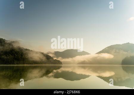 Morning fog atmosphere at Sylvenstein reservoir in Karwendel, Bavaria. Stock Photo