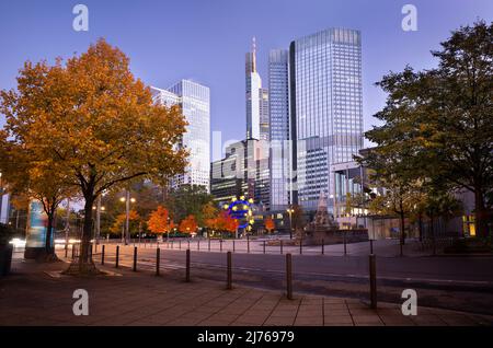 Germany, Hesse, Rhine-Main area, Frankfurt am Main, skyscrapers at Taunusanlage, banking district, Euro sculpture in front of the Eurotower at blue hour in autumn Stock Photo