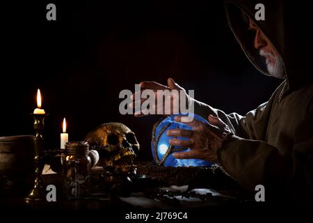 Old fortune teller with crystal ball Stock Photo