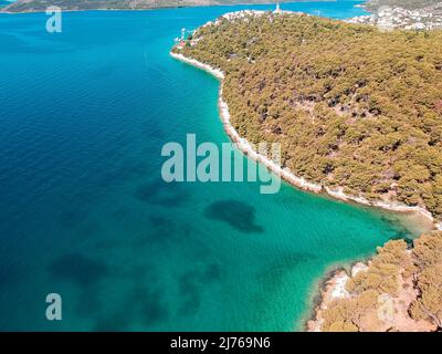 You can see the sea and a part of the area of Seget Vranjica in Croatia from above. In the foreground a lot of forest. Stock Photo