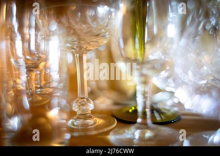 Collection of various beverage glasses in a wooden cabinet Stock Photo