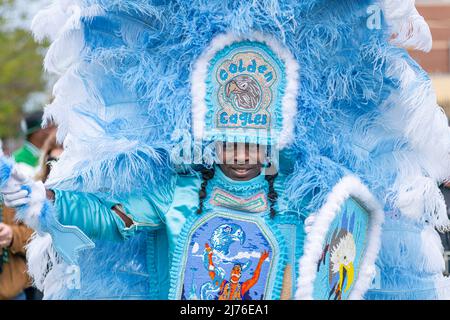 NEW ORLEANS, LA, USA - MARCH 17, 2019: Member of the Golden Eagles Mardi Gras Indian tribe poses on LaSalle Street on Super Sunday Stock Photo
