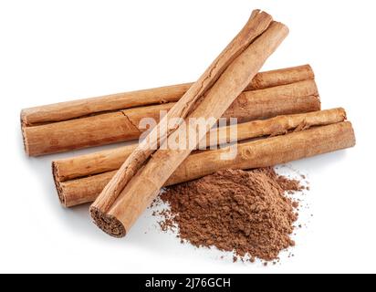 Cinnamon dried bark strips and cinnamon powder, sweet-smelling brown substance used in cooking, isolated on white background. Stock Photo