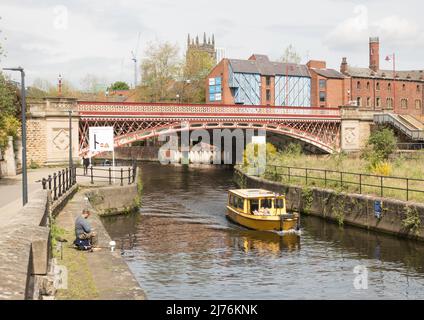 A Leeds Dock water taxi passes under the Crown Point Bridge over the river Aire in Leeds, Yorkshire, England, UK Stock Photo