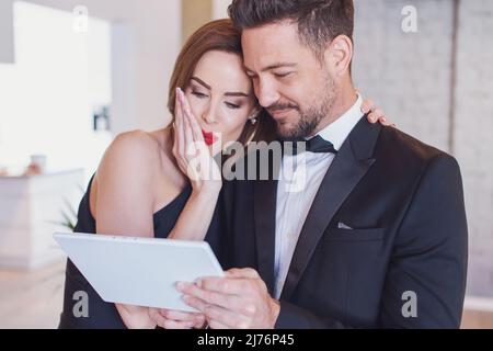 Happy young stylish white couple browsing by tablet, woman surprised Stock Photo