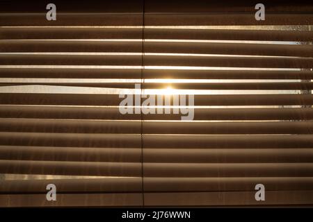 Light and shadow from the window on evening. Sun in jalousie Stock Photo