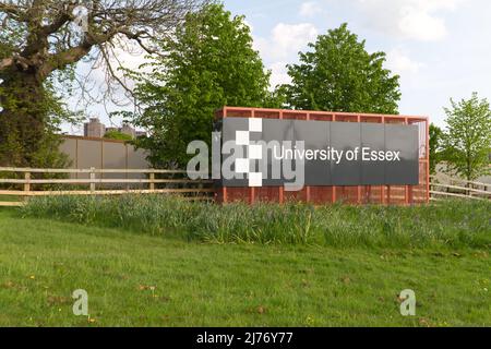 The entrance sign on Boundary Road that leads into the University of Essex in Colchester. The towers in the background are part of the campus. Stock Photo