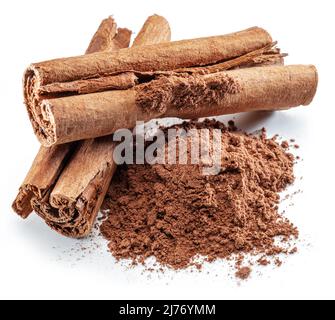Cinnamon dried bark strips and cinnamon powder, sweet-smelling brown substance used in cooking, isolated on white background. Stock Photo
