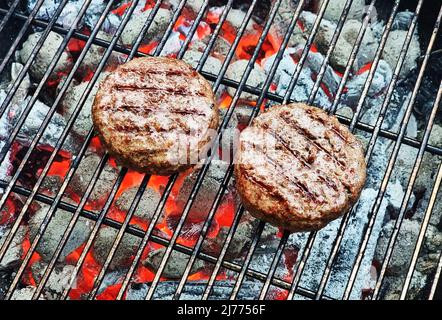 Grilling beef steaks on open grill grate. Photo of meat or barbeque cooking process. Stock Photo