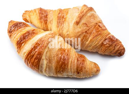 Tasty crusty croissants close-up on a white background. Stock Photo