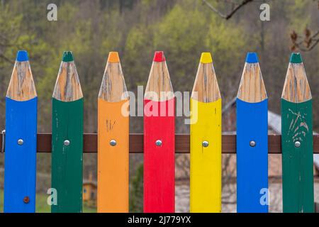 Colorful decorative wooden fence that resembles sharpened crayons or pencils Stock Photo