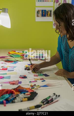Latin fashion designer working on new models on her desk Stock Photo
