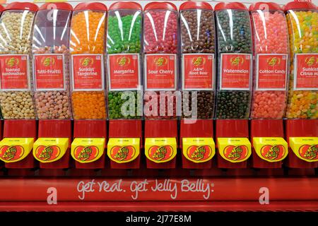 A Jelly Belly brand jelly bean dispenser with assorted flavors for sale by the pound at a retail candy store. Stock Photo