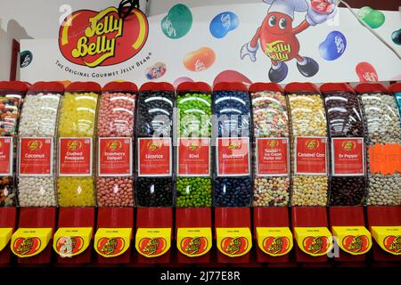 A Jelly Belly brand jelly bean dispenser with assorted flavors for sale by the pound at a retail candy store. Stock Photo