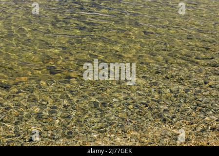 Clean water and pebbles texture. Natural background Stock Photo