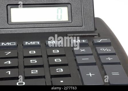 Partial view closeup of black plastic jumbo big buttons hand calculator with zero on digital display on white background Stock Photo