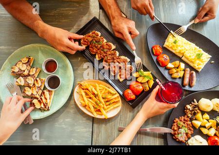 Group of friends having breakfast in the restaurant Stock Photo