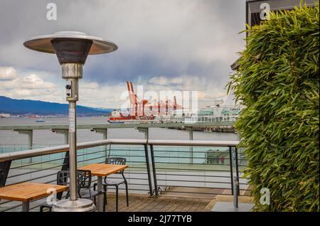 Round Mushroom Propane Patio Heater in outdoor restaurant patio. Gas heater for patio-April 11,2022-Vancouver BC, Canada. Street photo, travel photo, Stock Photo
