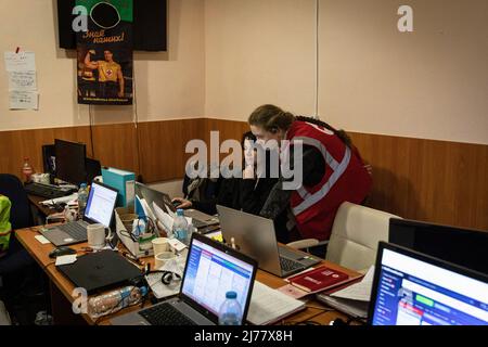 Two staff from Red Cross working in a call centre in the Red Cross office located in Kharkiv. Despite constant shelling from Russian troops encircling the city of Kharkiv, medical professionals and volunteers from Red Cross now continued their 24/7 work on saving lives and helping people in need. (Photo by Alex Chan Tsz Yuk / SOPA Images/Sipa USA) Stock Photo