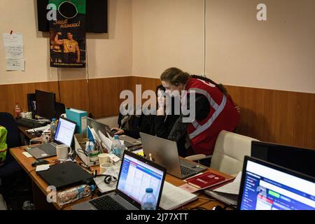 April 25, 2022, Kharkiv, Kharkivs'ka Oblast"", Ukraine: Two staff from Red Cross working in a call centre in the Red Cross office located in Kharkiv. Despite constant shelling from Russian troops encircling the city of Kharkiv, medical professionals and volunteers from Red Cross now continued their 24/7 work on saving lives and helping people in need. (Credit Image: © Alex Chan Tsz Yuk/SOPA Images via ZUMA Press Wire) Stock Photo