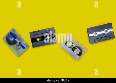 Old compact cassette tape on yellow background Stock Photo
