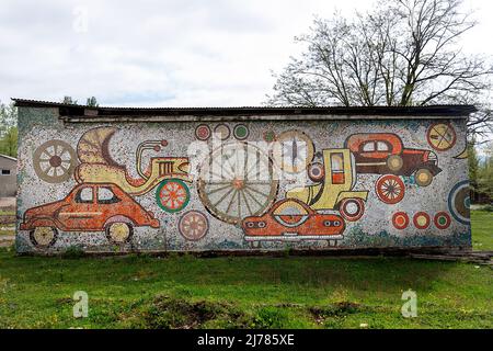 Soviet Mosaic on a building in Georgia, vintage transport theme, street art of the past by the road near Chiatura, Georgia Stock Photo