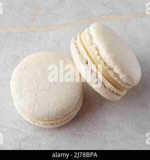 Sweet vanilla macarons on a stone background. Traditional French dessert Stock Photo