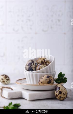Bowl with quail eggs on light background Stock Photo