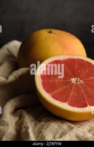 sliced ripe grapefruit on a light cloth Stock Photo