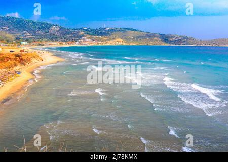 Sarti, Greece summer greek beach vacation panorama with turquoise sea water waves and umbrellas Stock Photo