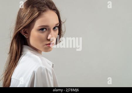 Portrait of sophisticated young woman advertising products and services. Stock Photo