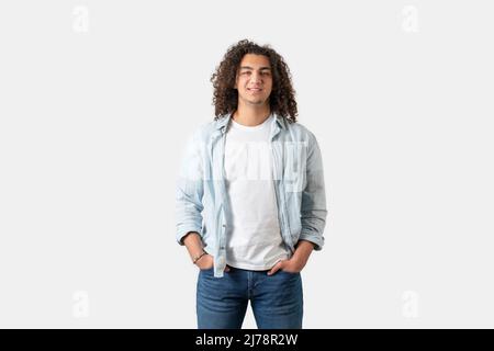 Close up of young good looking man with long and curly hair is posing, isolated on white background. High quality photo Stock Photo