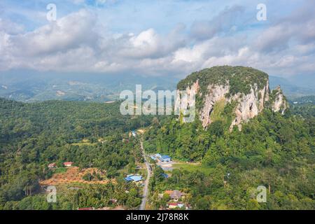 Aerial view to the Limestone hill  Bukit Batu Kapur at Cinta Manis, Pahang, Malaysia. A mountain rock out of nowhere in the middle of the Malaysian ra Stock Photo