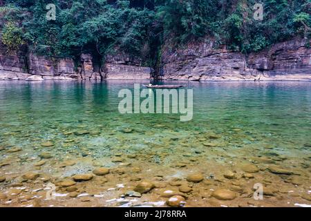 river clear water with traditional wood boat running at morning from different angle image is taken at umtong river dawki meghalaya india on Apr 03 20 Stock Photo