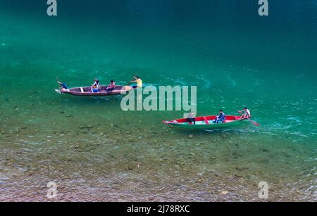 river clear water with traditional wood boat running at morning from different angle image is taken at umtong river dawki meghalaya india on Apr 03 20 Stock Photo