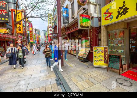Yokohama, Japan - April 21, 2017: Chinatown pedestrian street walking area with chinese people wearing face mask. Stock Photo