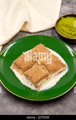 Cold baklava. Baklava with milk on a dark background. Mediterranean cuisine delicacies. Close-up. Local name soguk baklava Stock Photo