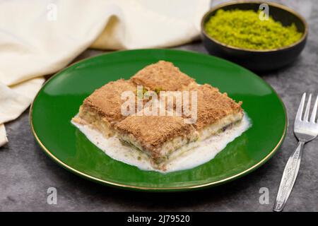 Cold baklava. Baklava with milk on a dark background. Mediterranean cuisine delicacies. Close-up. Local name soguk baklava Stock Photo