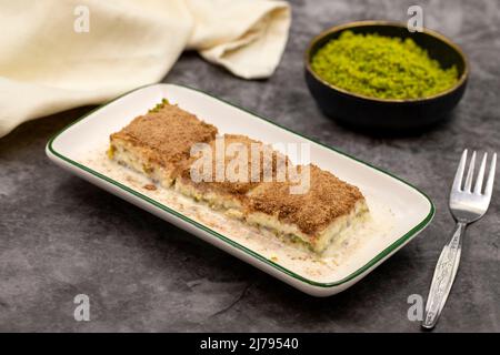 Cold baklava. Baklava with milk on a dark background. Mediterranean cuisine delicacies. Close-up. Local name soguk baklava Stock Photo