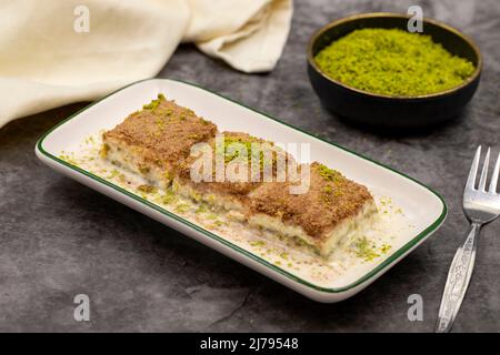 Cold baklava. Baklava with milk on a dark background. Mediterranean cuisine delicacies. Close-up. Local name soguk baklava Stock Photo