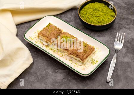 Cold baklava. Baklava with milk on a dark background. Mediterranean cuisine delicacies. Close-up. Local name soguk baklava Stock Photo