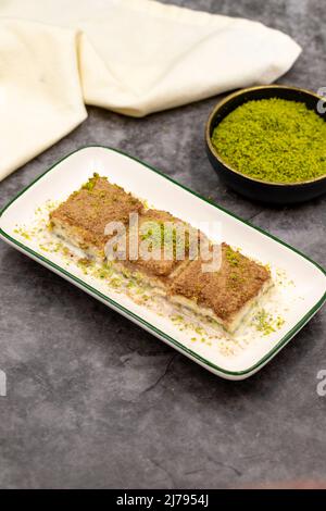 Cold baklava. Baklava with milk on a dark background. Mediterranean cuisine delicacies. Close-up. Local name soguk baklava Stock Photo