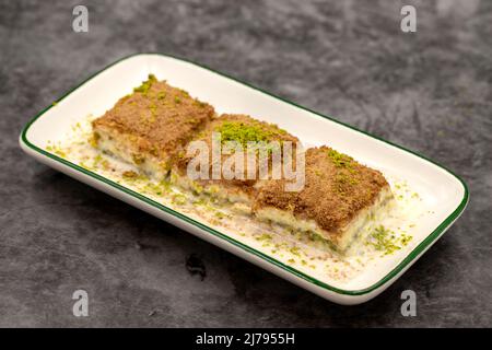 Cold baklava. Baklava with milk on a dark background. Mediterranean cuisine delicacies. Close-up. Local name soguk baklava Stock Photo