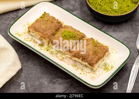 Cold baklava. Baklava with milk on a dark background. Mediterranean cuisine delicacies. Close-up. Local name soguk baklava Stock Photo