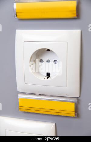 a white 220 volt outlet on a gray wall. Stock Photo