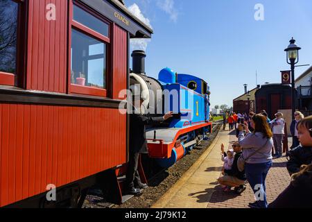 Ronks, PA, USA - April 30, 2022: A conductor waves to children from a train car during the Thomas the Tank Engine Days at the Strasburg Rail Road in r Stock Photo