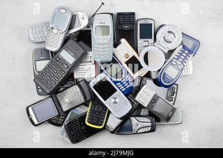 Prague, CZ - 12 December 2021: A lot of old used mobile phones with ...