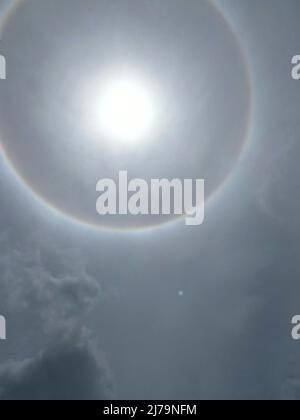 Sun halo from upper atmosphere ice - Grenada, Caribbean, mid-day May 7th 2022 Stock Photo